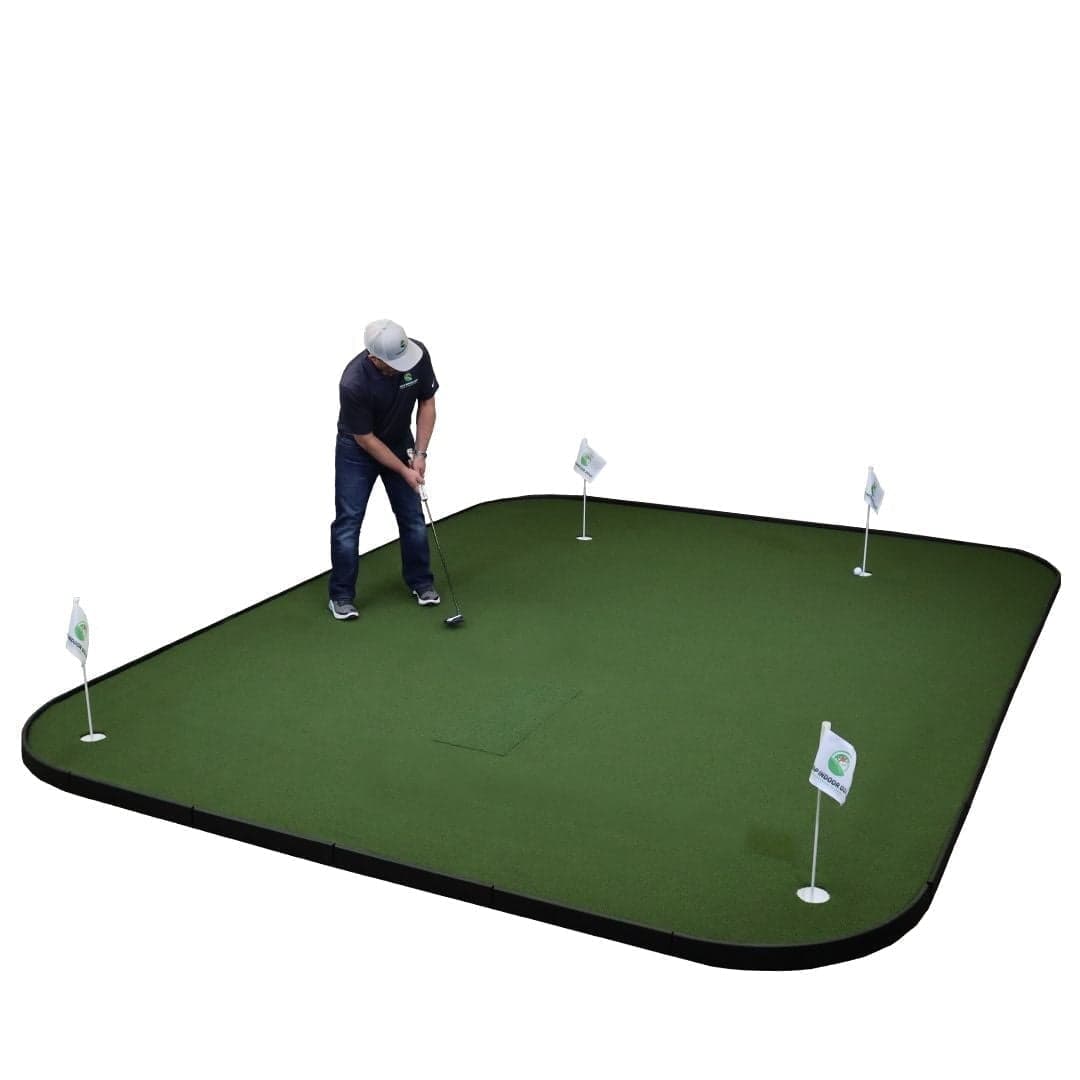 SIGPRO golf simulator flooring laid out with putting cups and flagsticks and a hitting-mat inset at centre, golfer putting on the surface