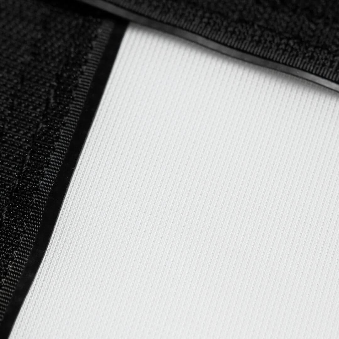 SIG Premium impact screen material, folded corner showing the white face and black backing
